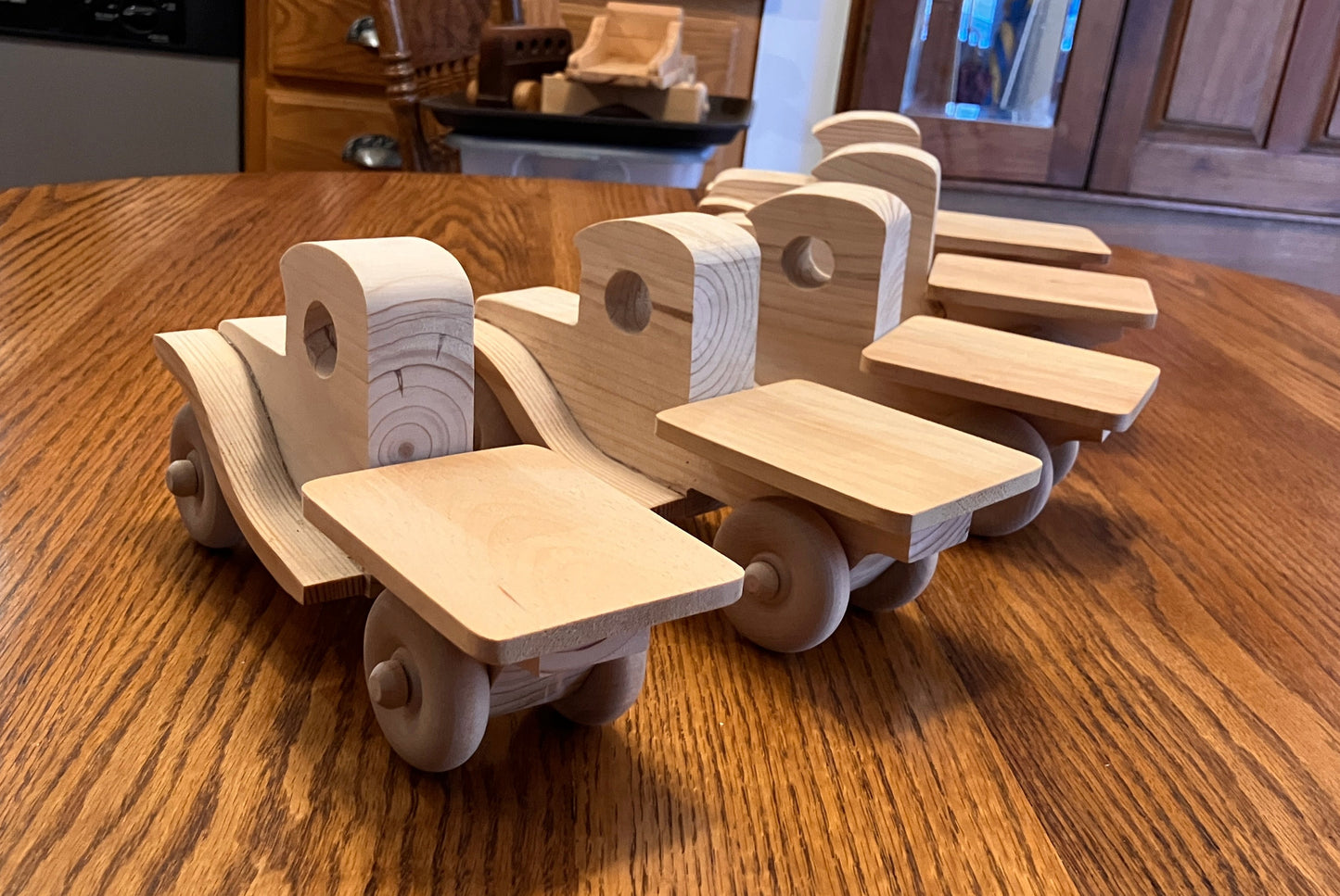 Wooden toy pickup truck on a wooden table