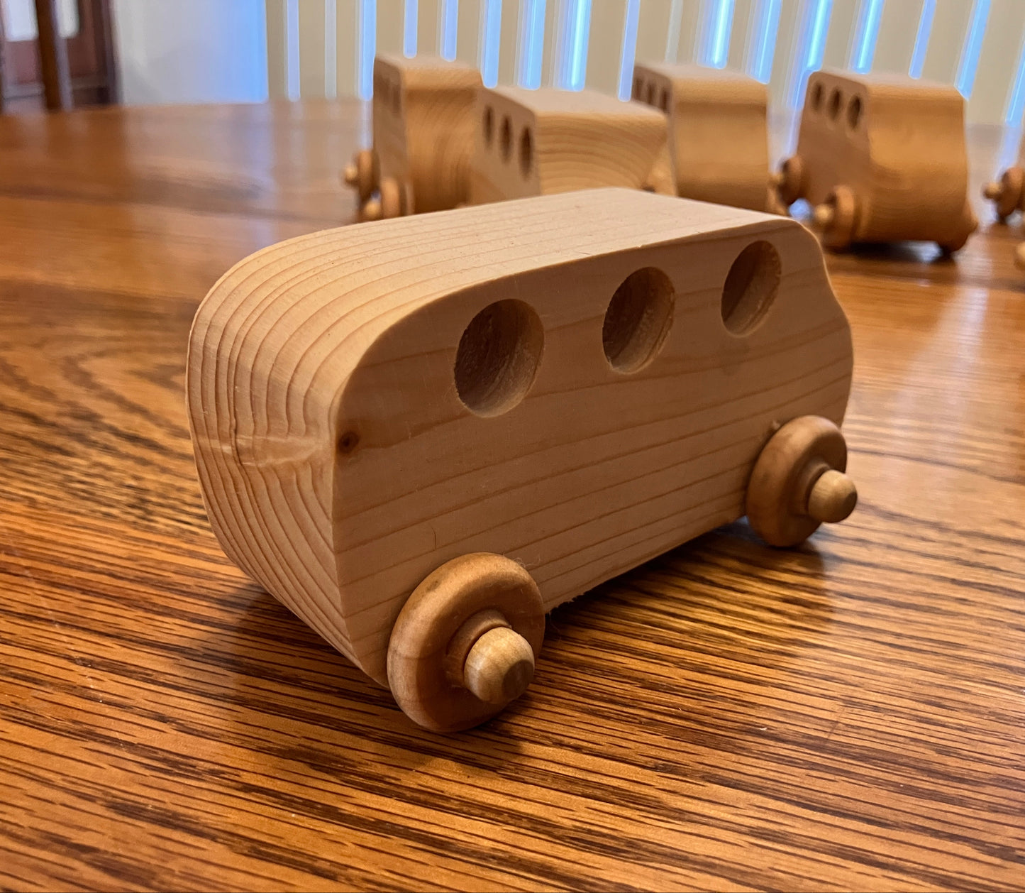 Wooden toy bus on a wooden table