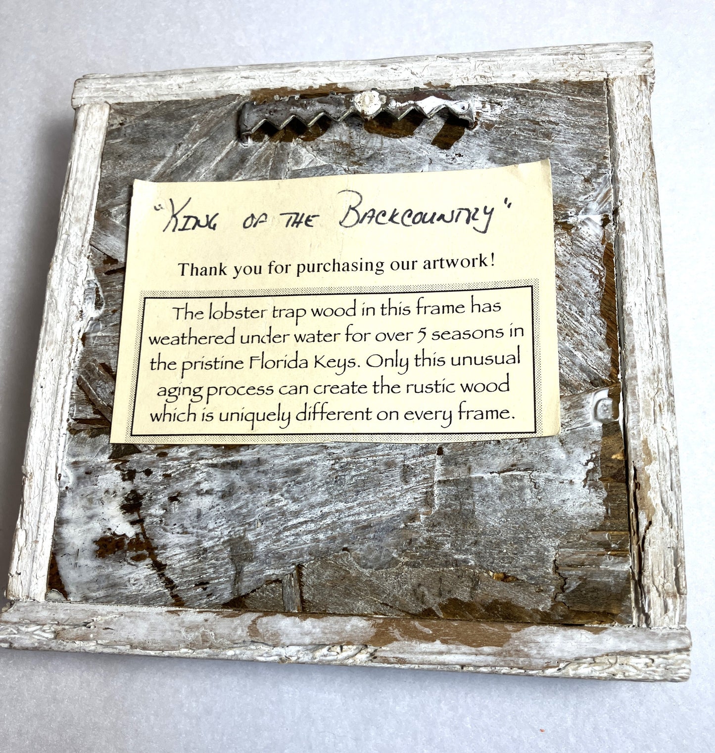 Wooden Lobster Trap frame with rustic finish and a label describing the origin of the frame