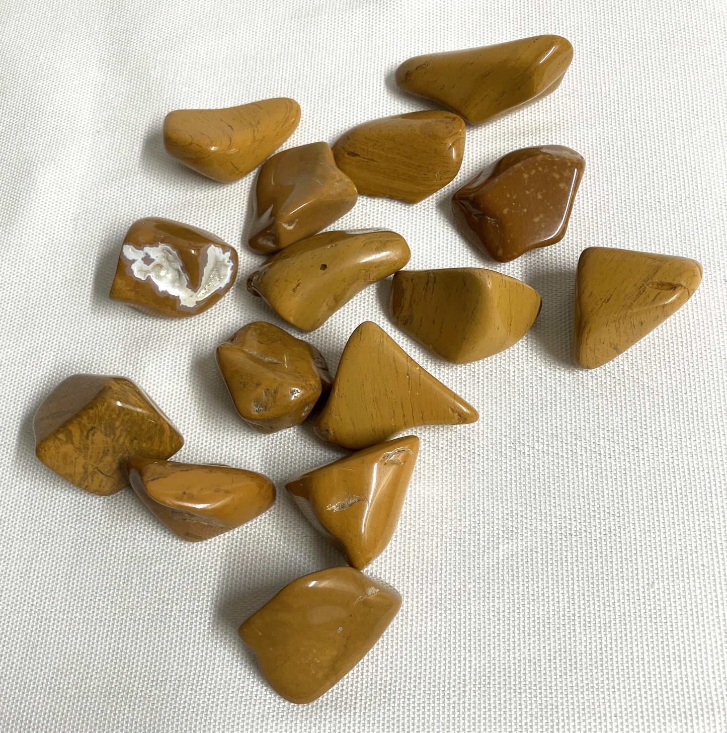 Back view of Yellow Jasper Crystals on a white fabric background