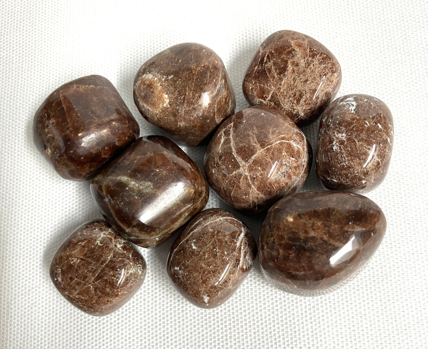 Closeup of Hessonite Garnet Crystals on a white fabric background