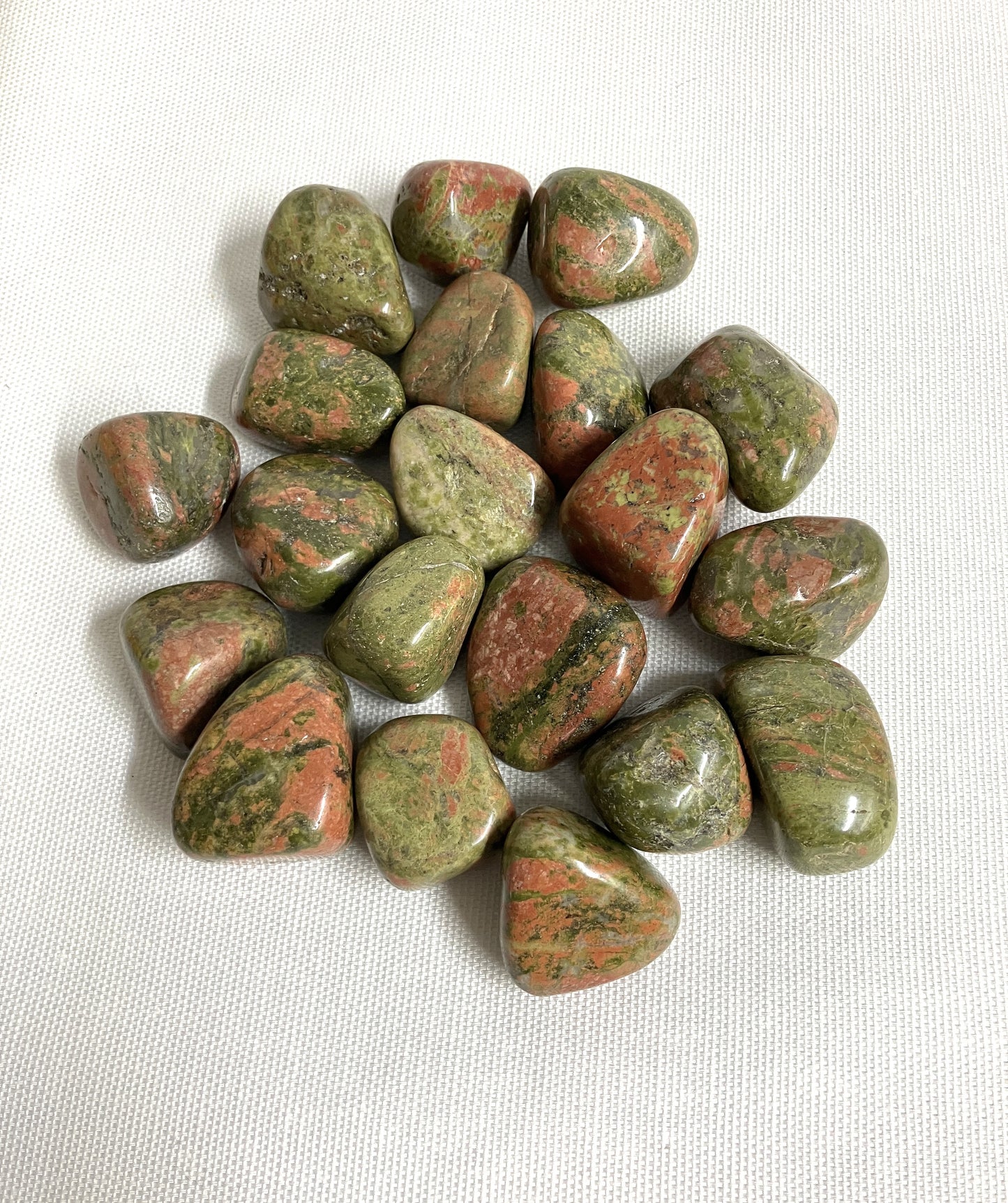 Closeup of Unakite Crystal on a white background