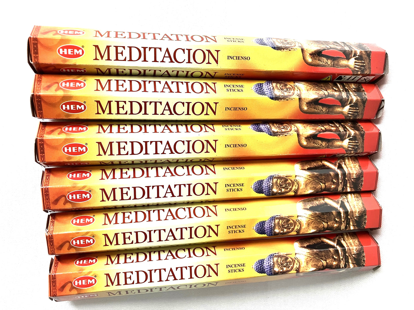Stack of HEM Meditation incense sticks packaging on a white background