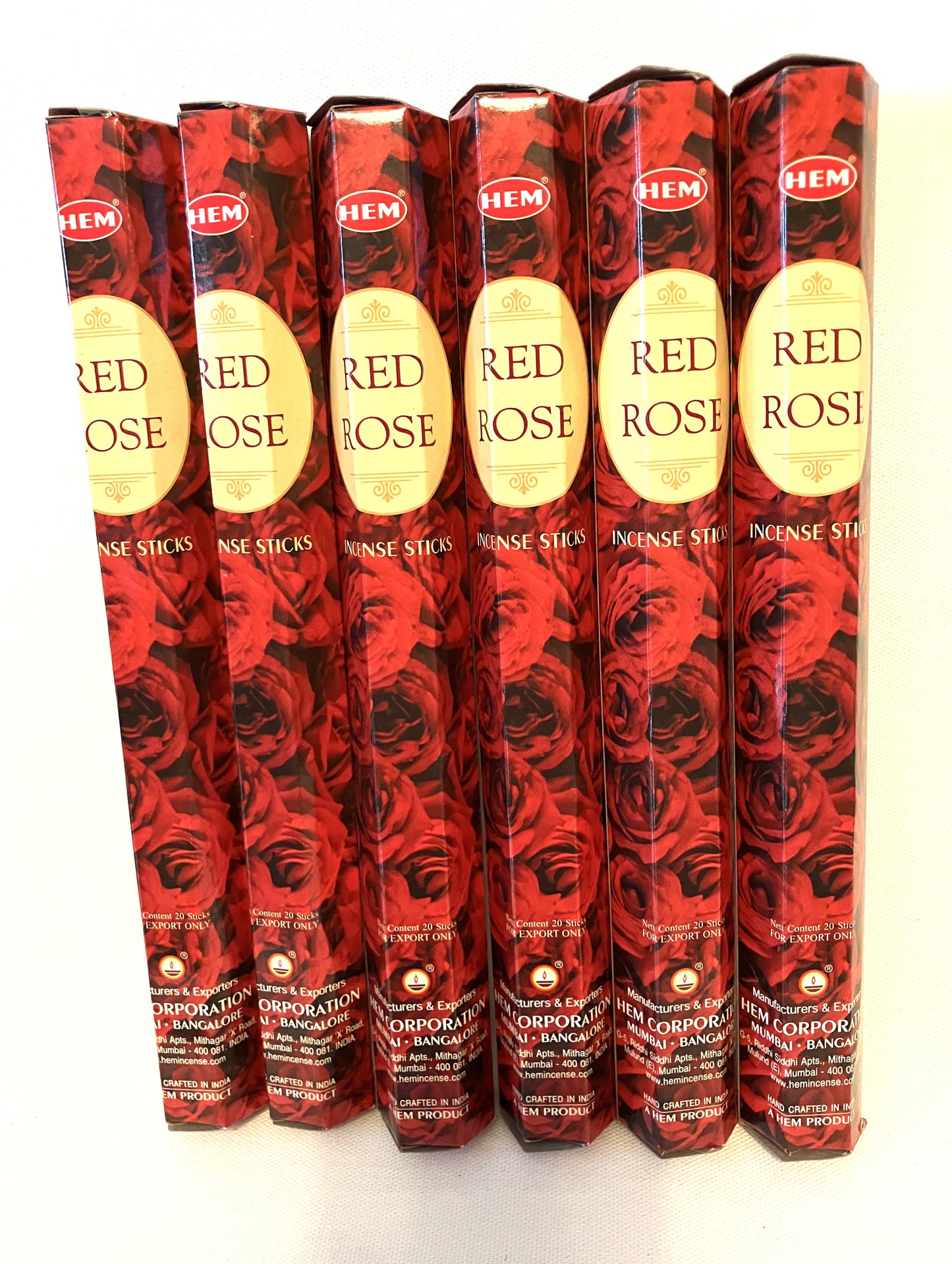 Multiple packages of HEM Red Rose incense sticks on a white background