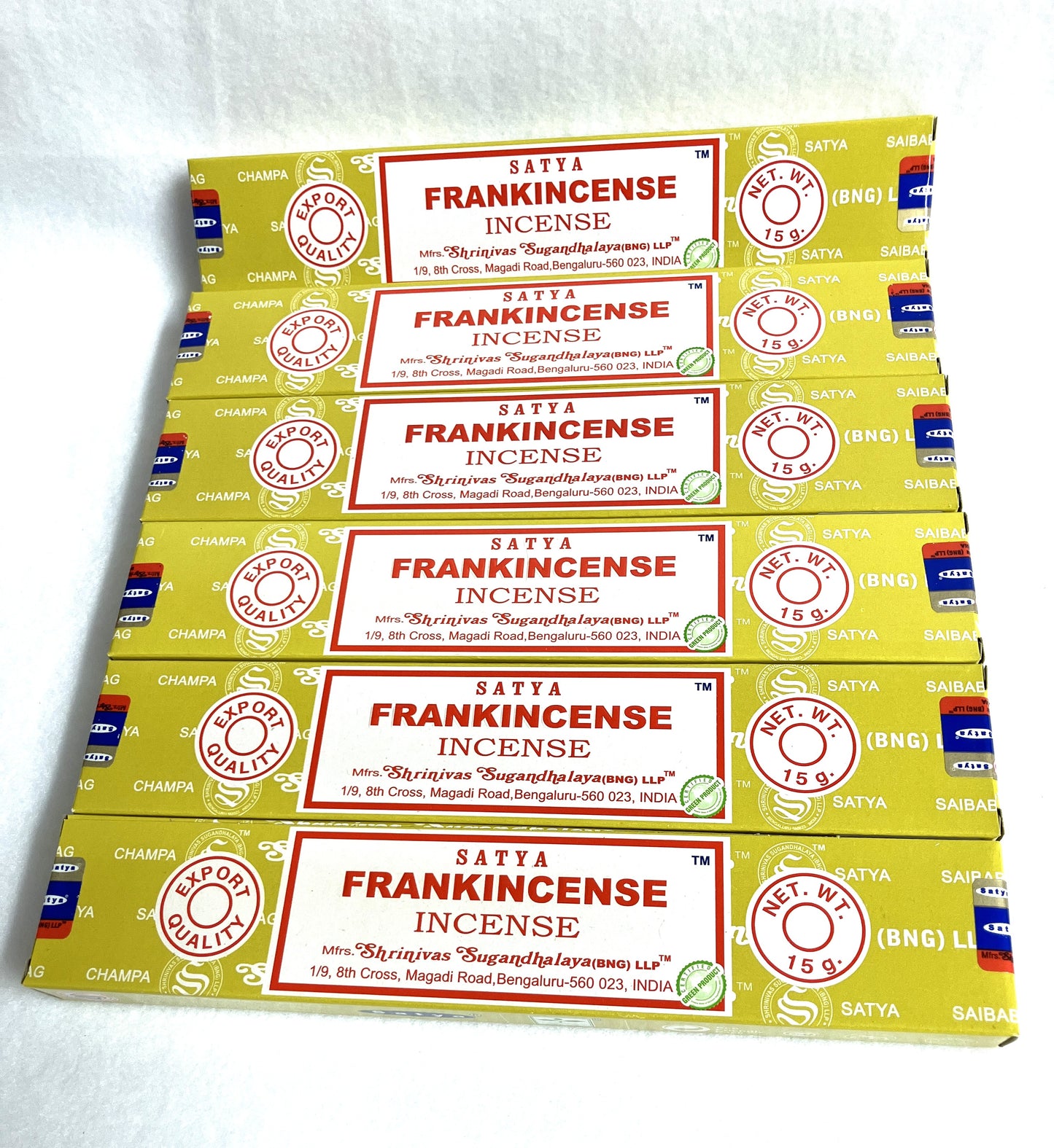 Multiple boxes of Satya Frankincense Incense stacked on a white background