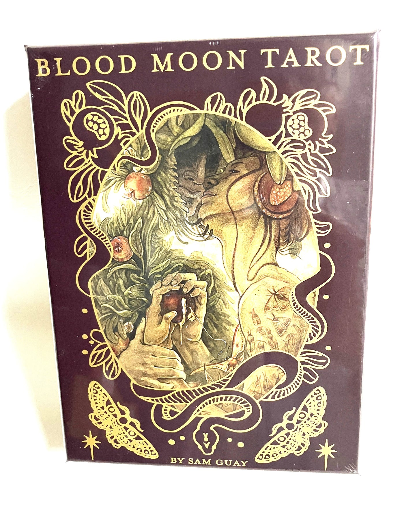 Cover of 'Blood Moon Tarot' by Sam Guay with intricate design and text.