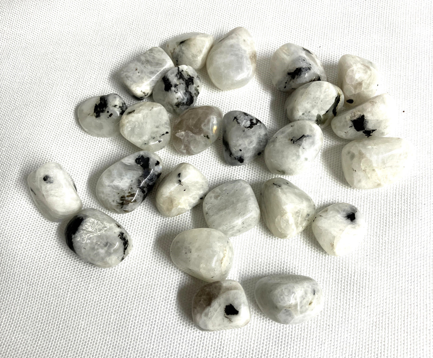 Rainbow Moonstone Crystals on a white fabric background