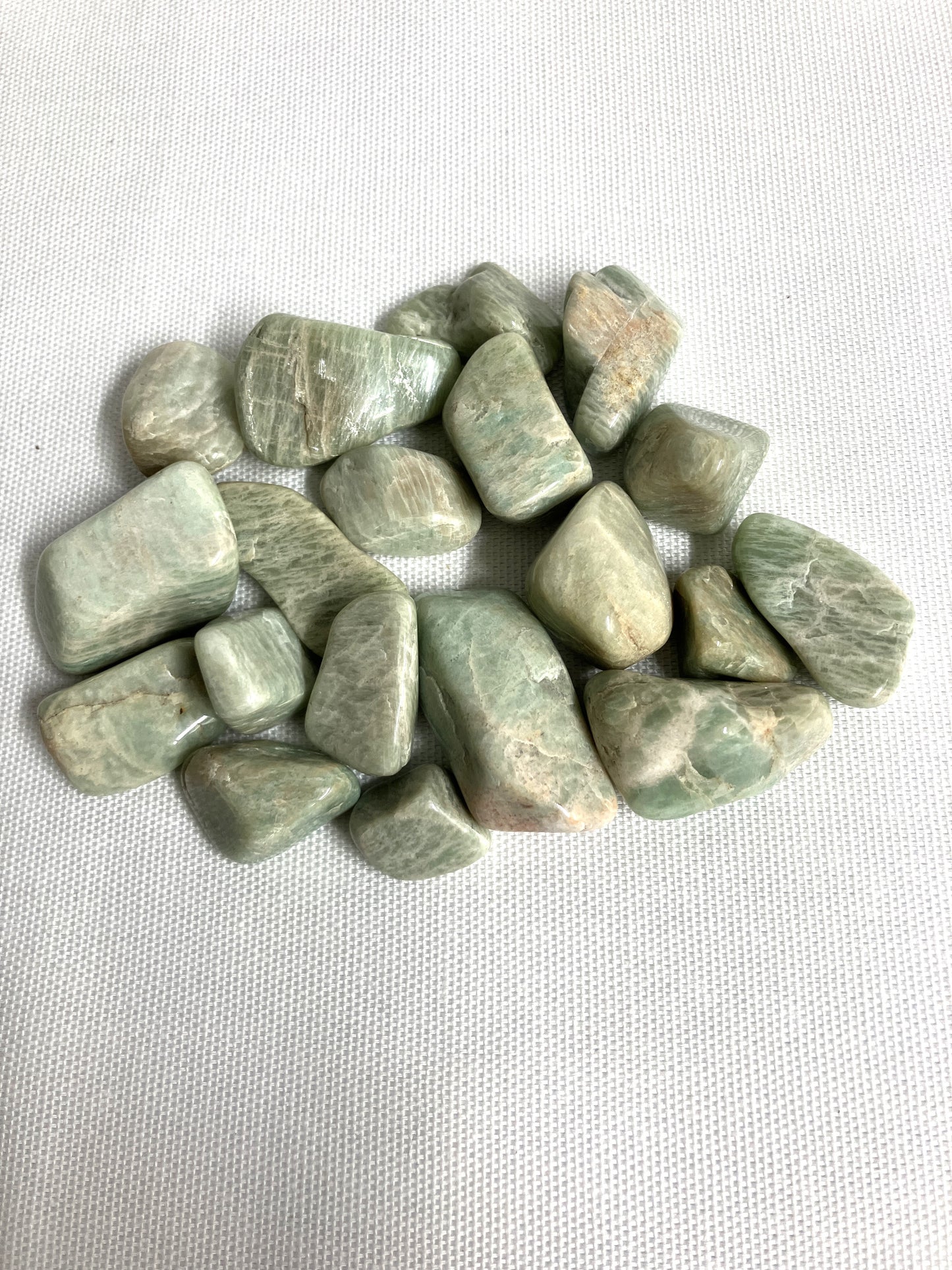 Back view of Amazonite Crystals on a white fabric background