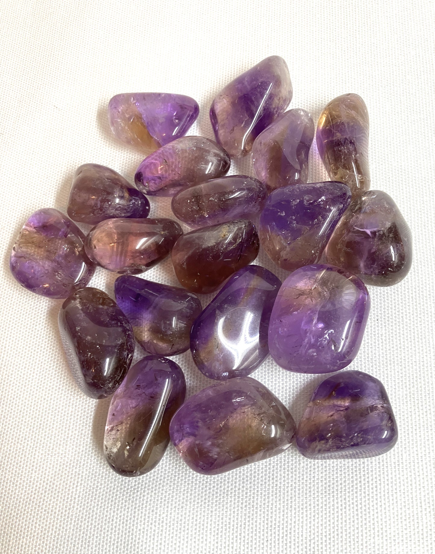 Collection of Ametrine Tumbled Crystals on a white background