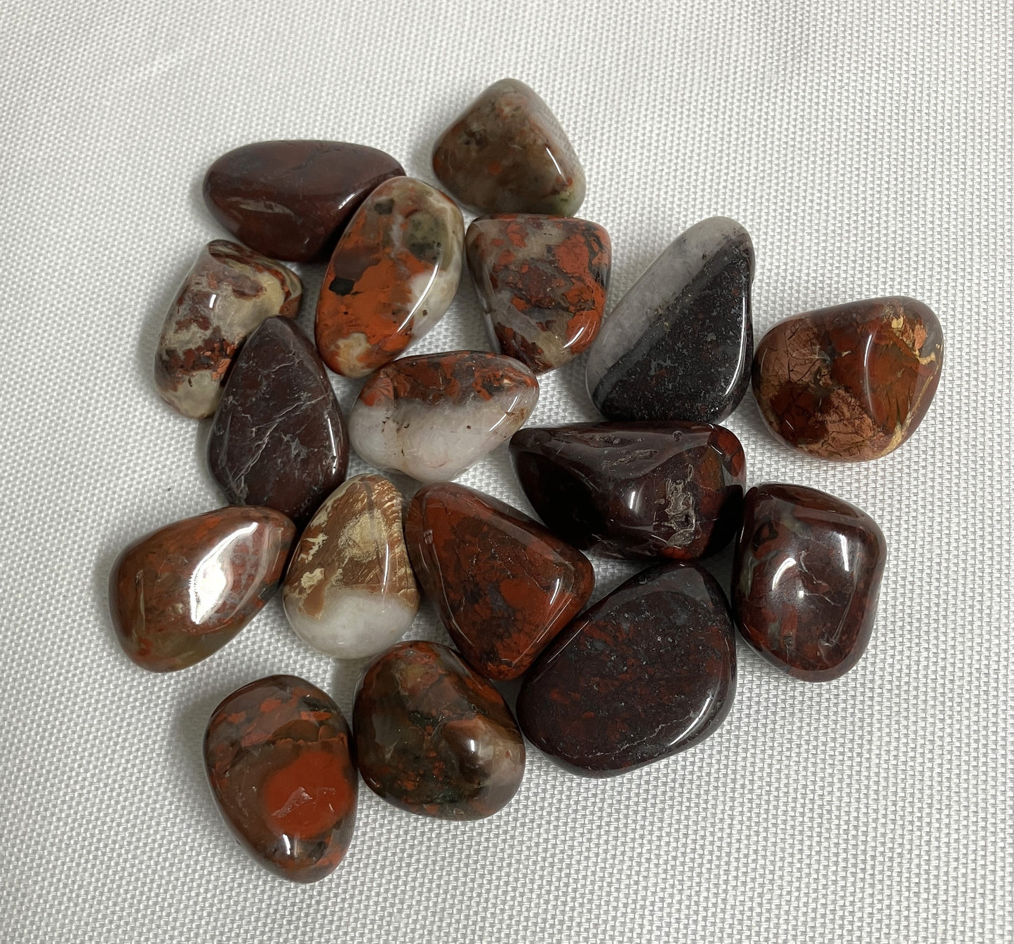 Collection of Brecciated Jasper Crystal on a textured white surface