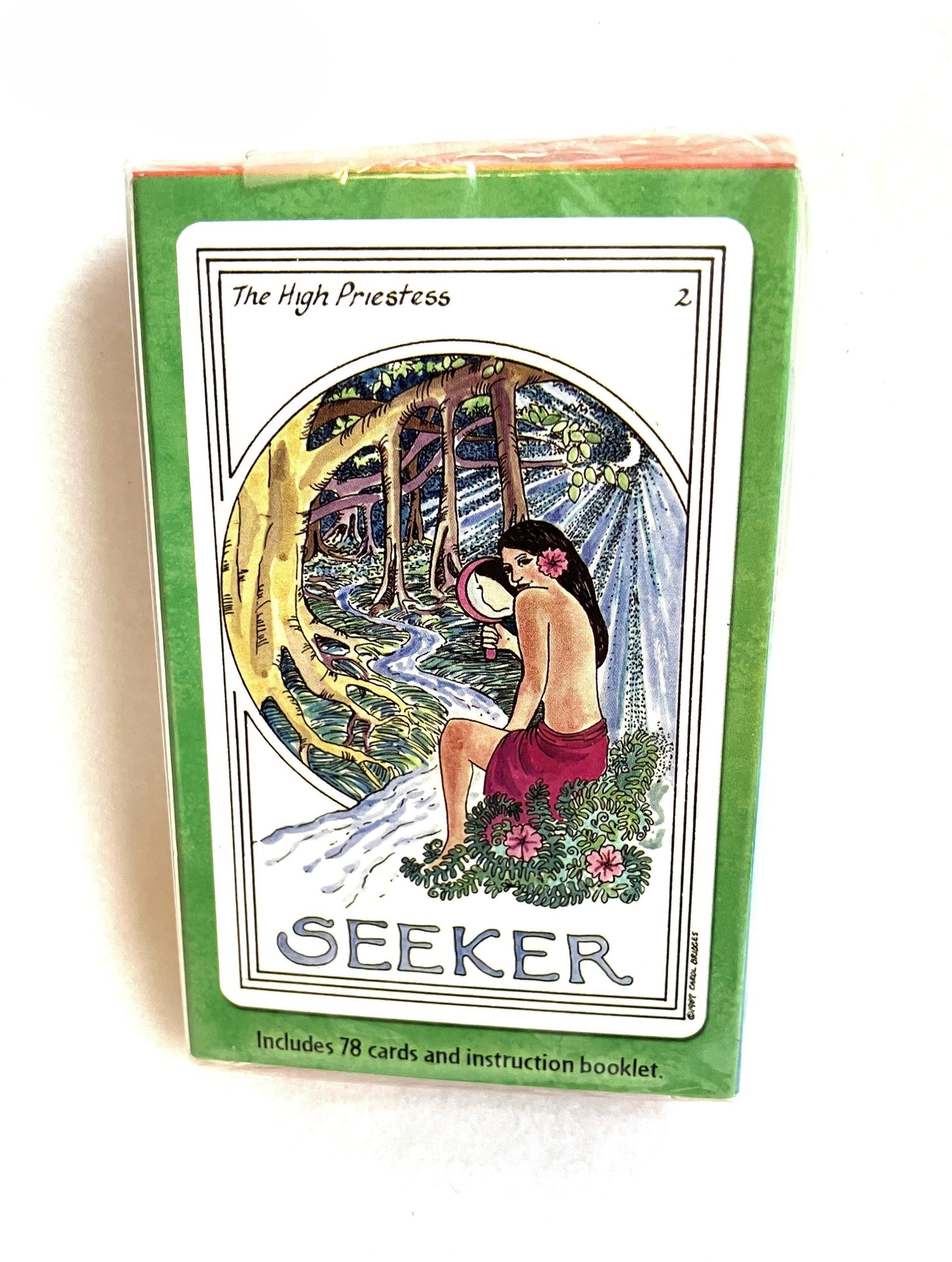 Medicine Woman Tarot Deck with the 'Seeker' tarot card illustration of a woman in a forest and text 'The High Priestess'.