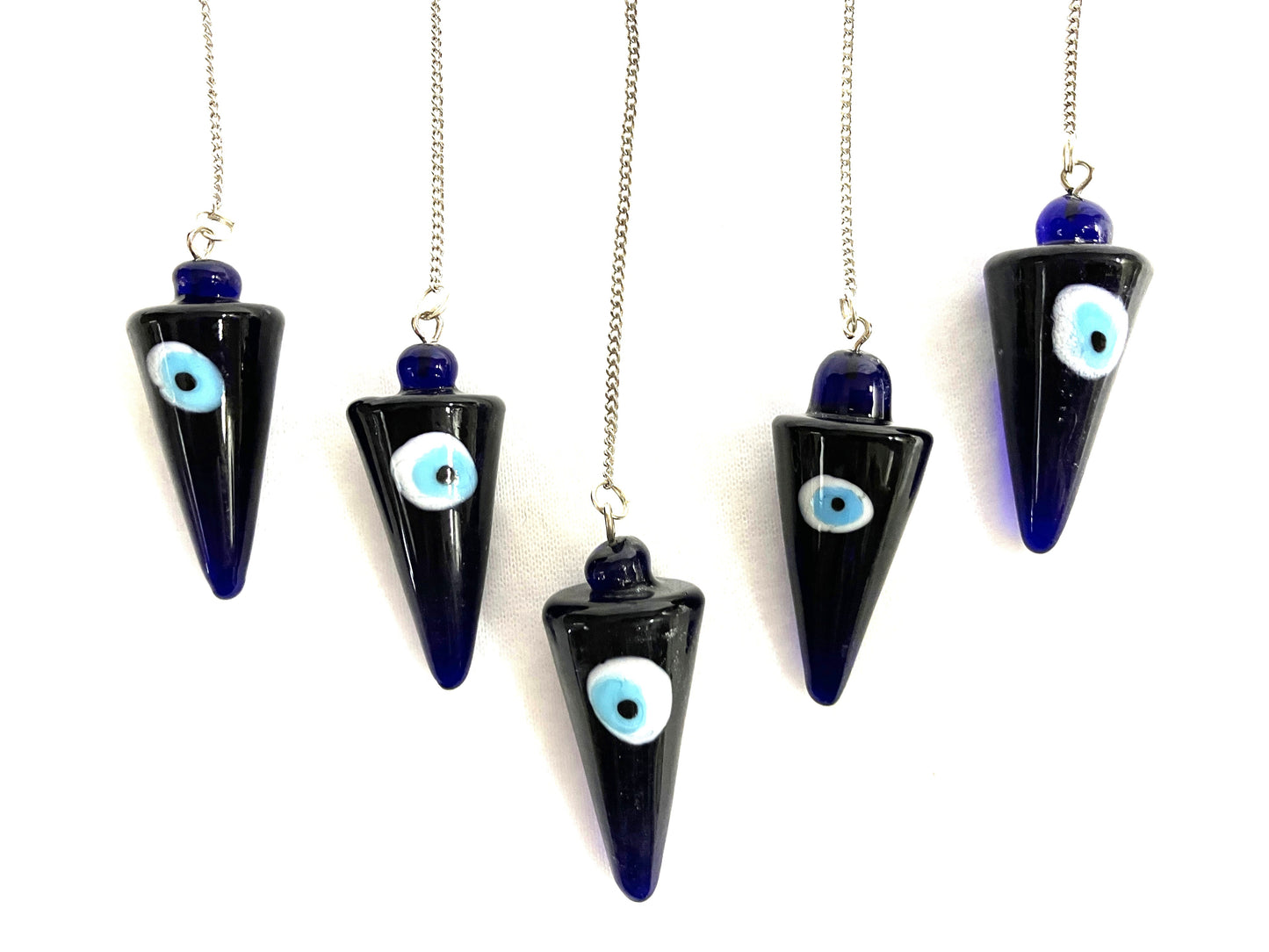 Five cobalt blue evil eye pendulums against a white background.