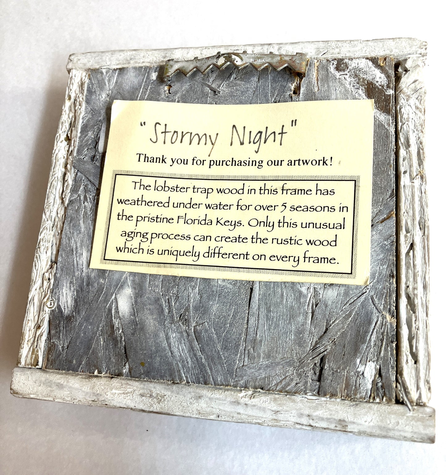 Wooden frame with 'Stormy Night' label depicting the origin of the frame on a white background