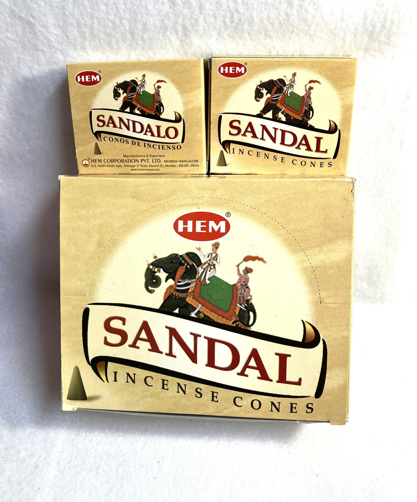 Hem Sandal incense cones with both Spanish and English titles on a white background. Individual boxes of 20 and a master carton shown