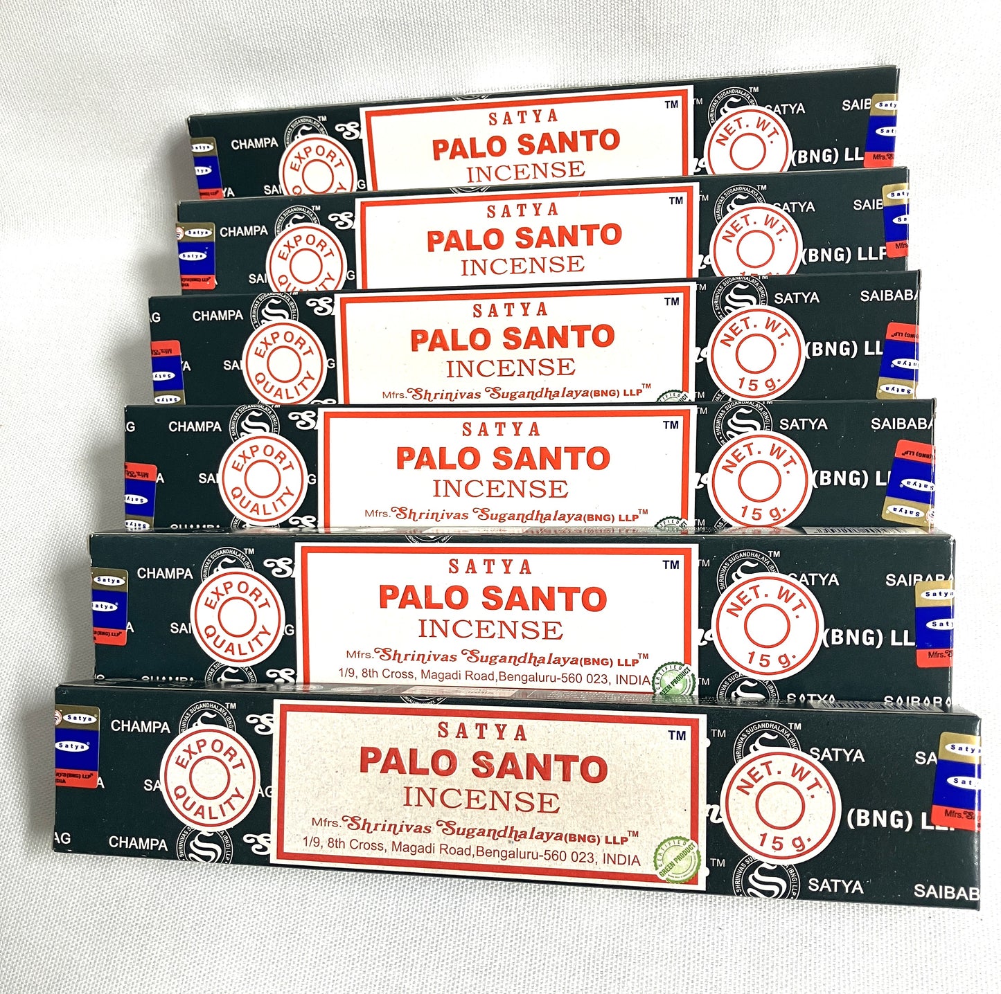Multiple boxes of Satya Palo Santo Incense stacked on a white background