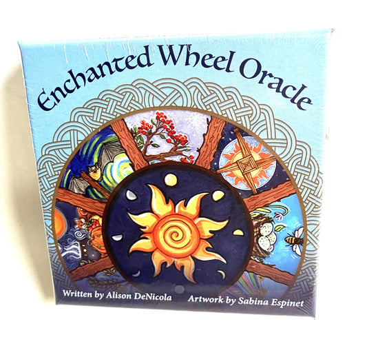 Box of 'Enchanted Wheel Oracle' with sun and moon design on a light blue background