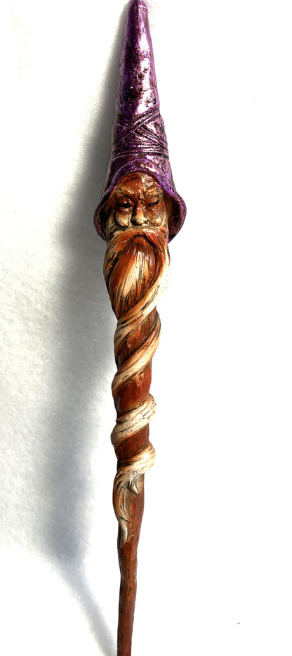 Wizard wand with a purple hat shown on a white background