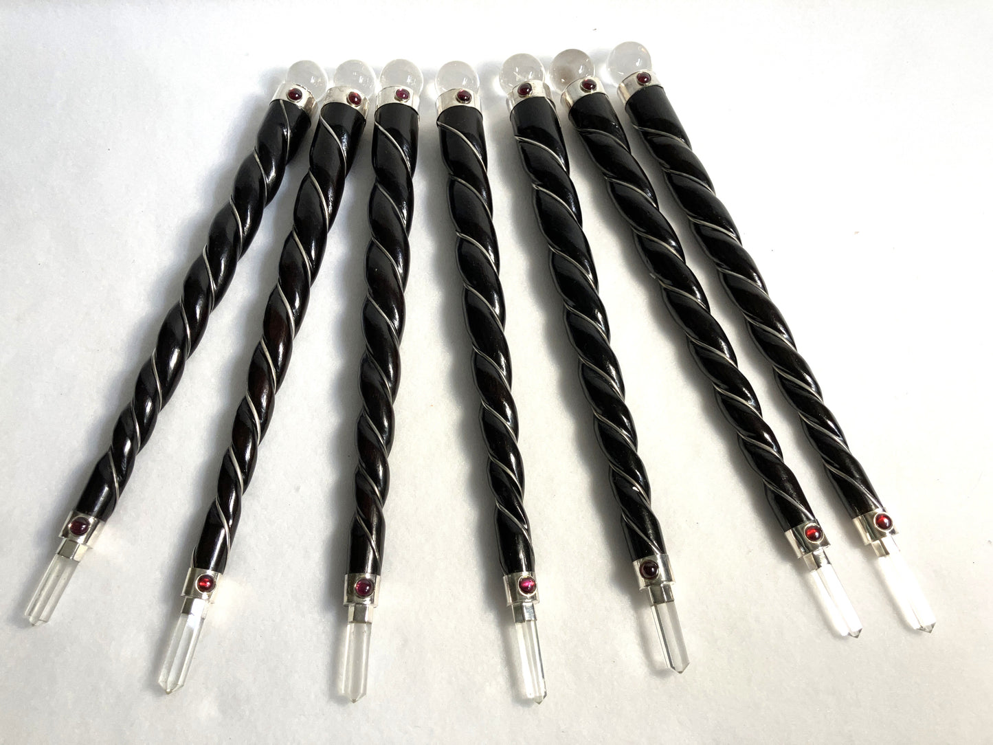 Group of Rosewood Twisted Wands with silver accents and quartz orb and point shown on a white background