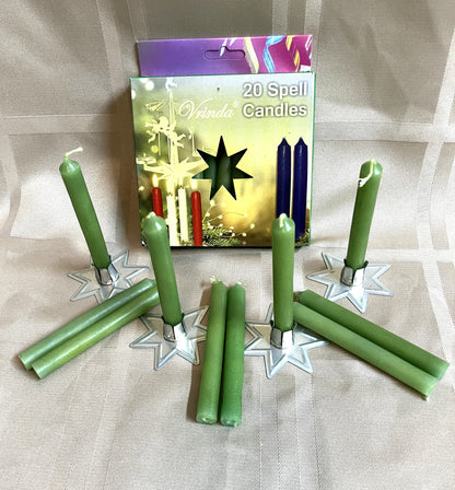 Green spell candles with a box labeled '20 Spell Candles' on a textured surface.
