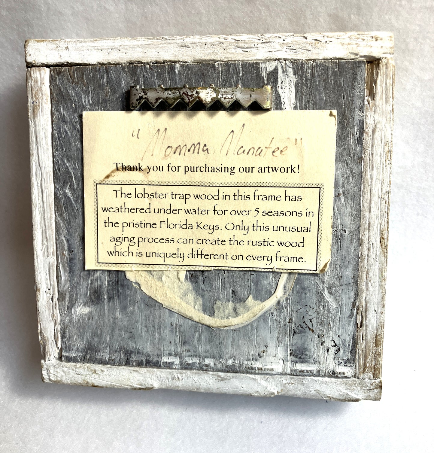 Wooden Lobster Trap frame with lobster trap and descriptive card on a gray background