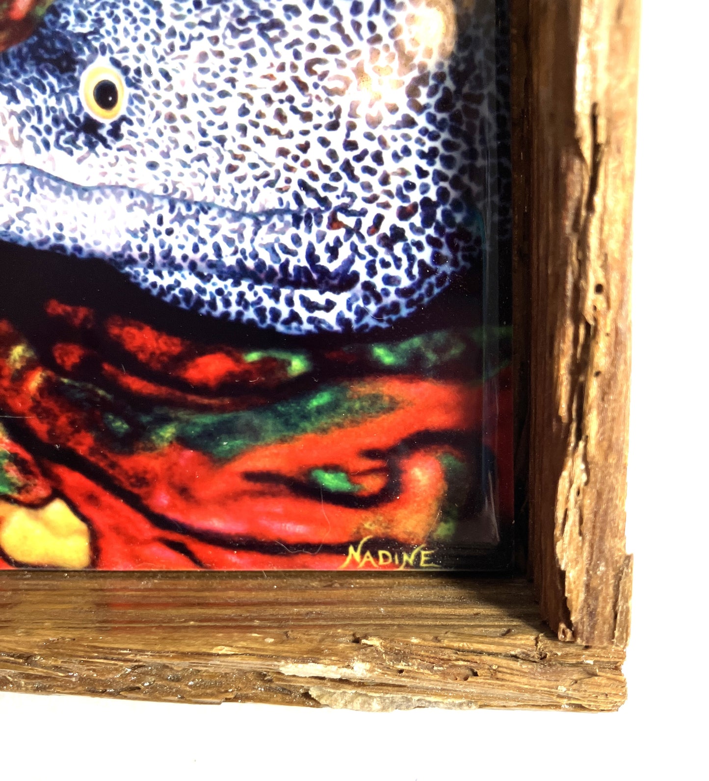 Close-up of a Morey Eel painting with a distressed wooden frame showing the artist's signature.