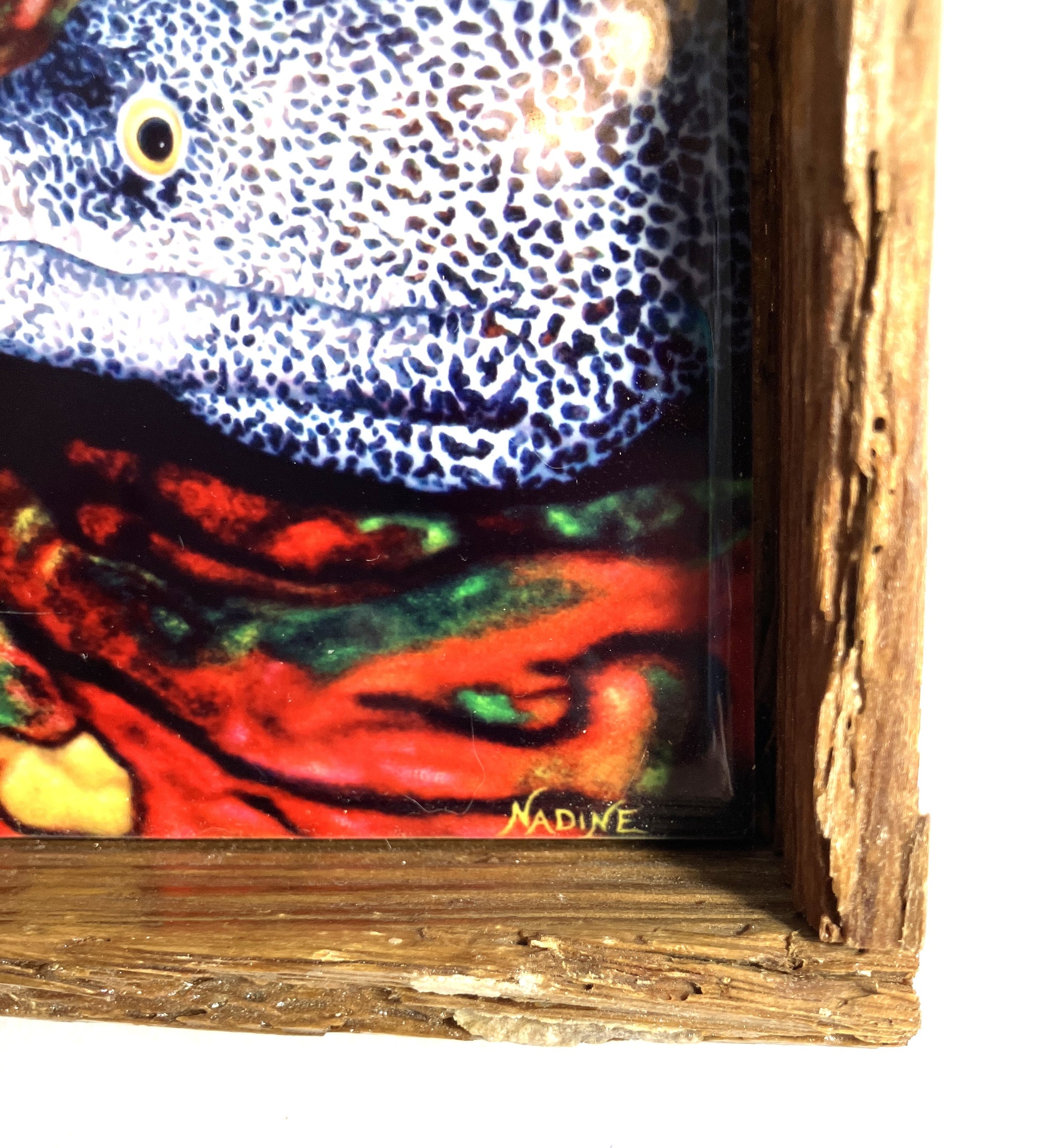 Close-up of a Morey Eel painting with a distressed wooden frame showing the artist's signature.