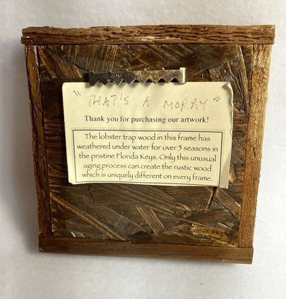 Distressed wooden frame with a rustic finish and a message card about the origin of the frame