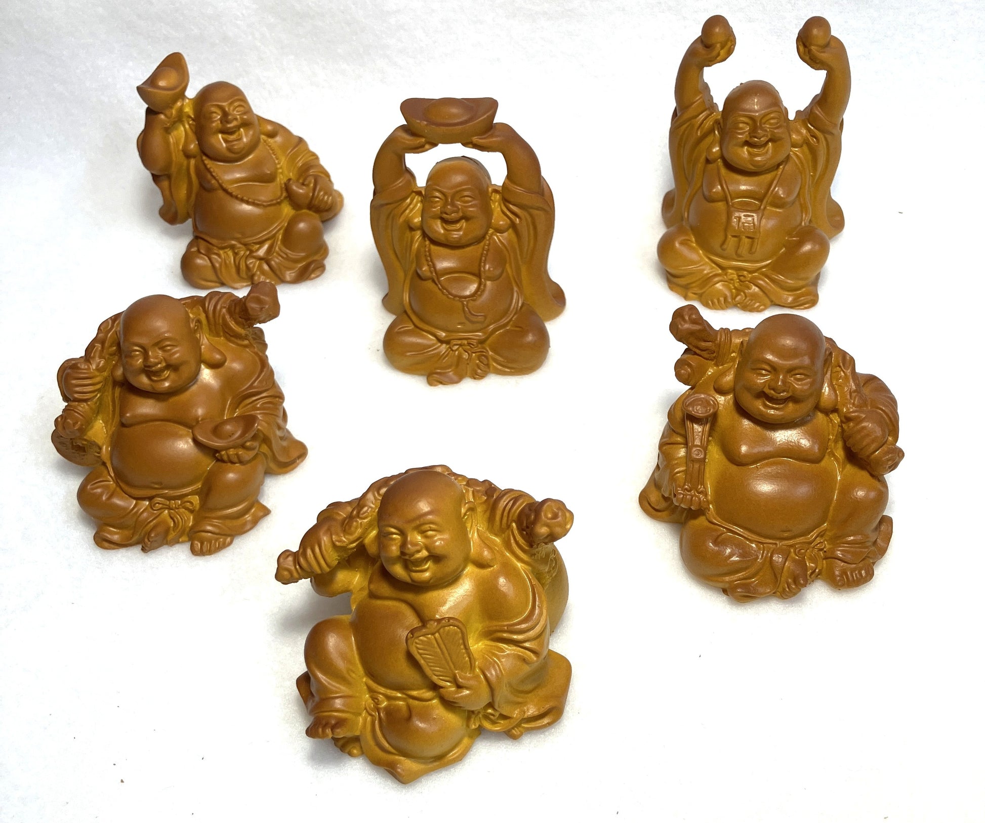 Set of six Laughing Buddha figurines shown on a white background
