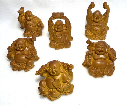 Set of six Laughing Buddha figurines shown on a white background