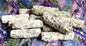 Group of White Sage smudge sticks shown on a swirled color background