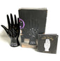 Black palm reading ceramic hand with a box and guidebook on a white background