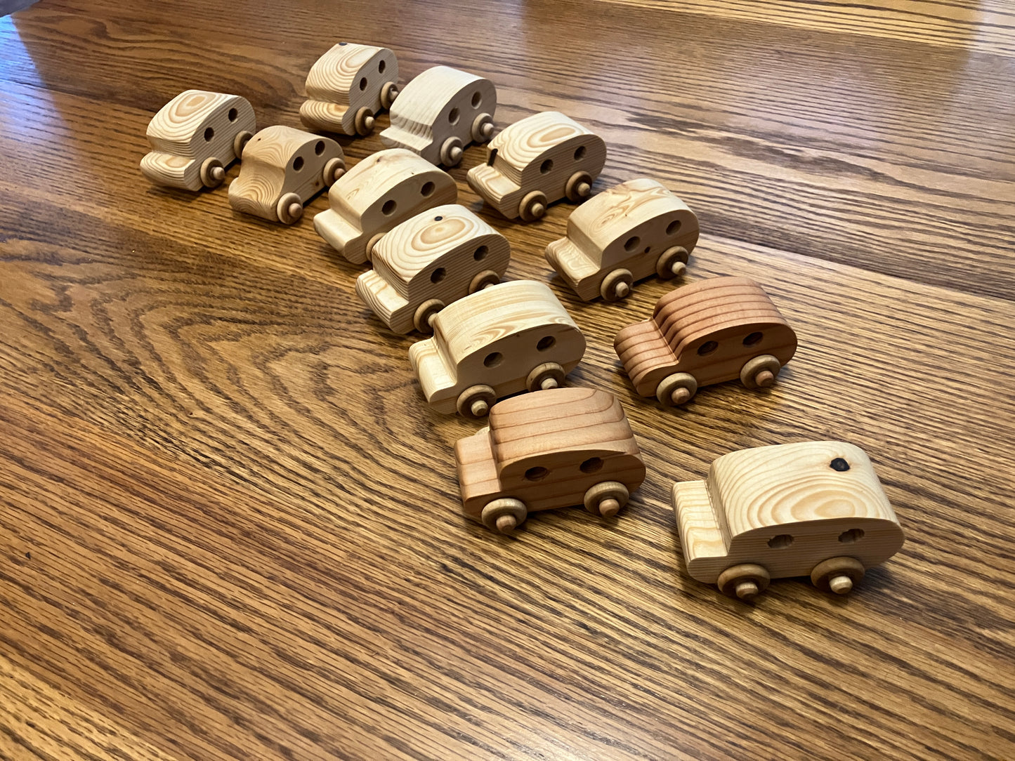Set of wooden toy cars on a wooden surface
