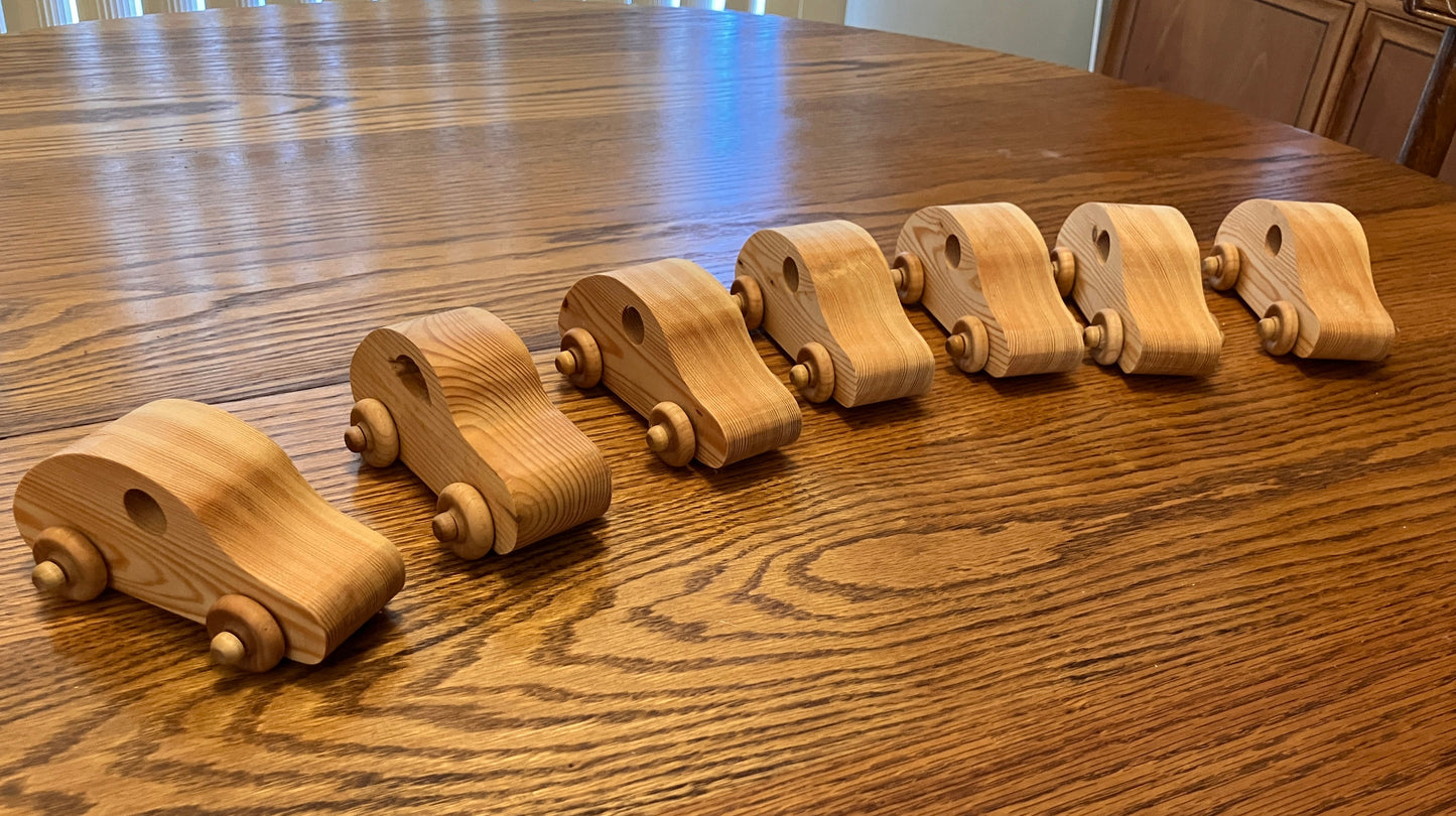 Set of wooden toy cars on a wooden table