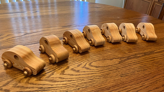 Set of wooden toy cars on a wooden table