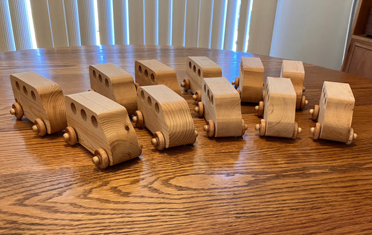 Set of wooden toy trucks arranged on a wooden table