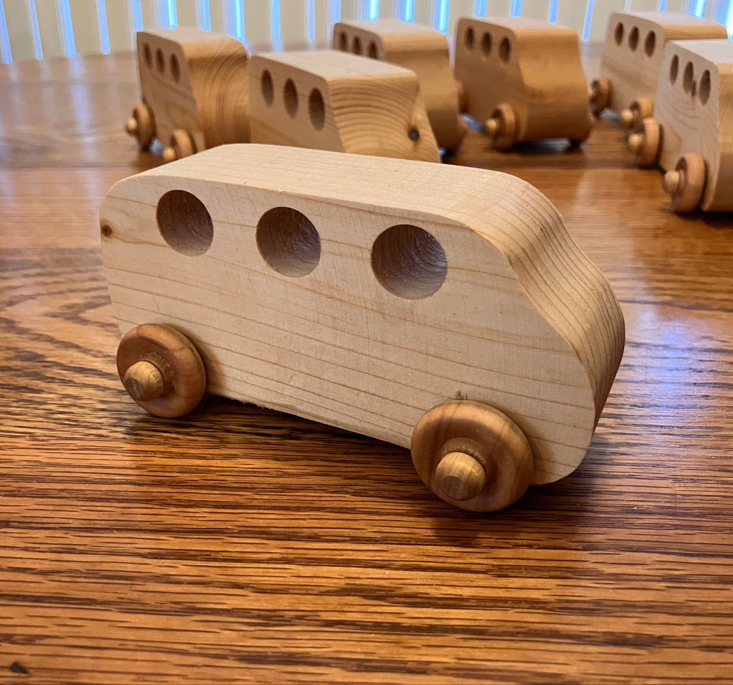 Wooden toy buses on a wooden table