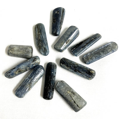 Blue Kyanite Crystals arranged in a circular pattern on a white background