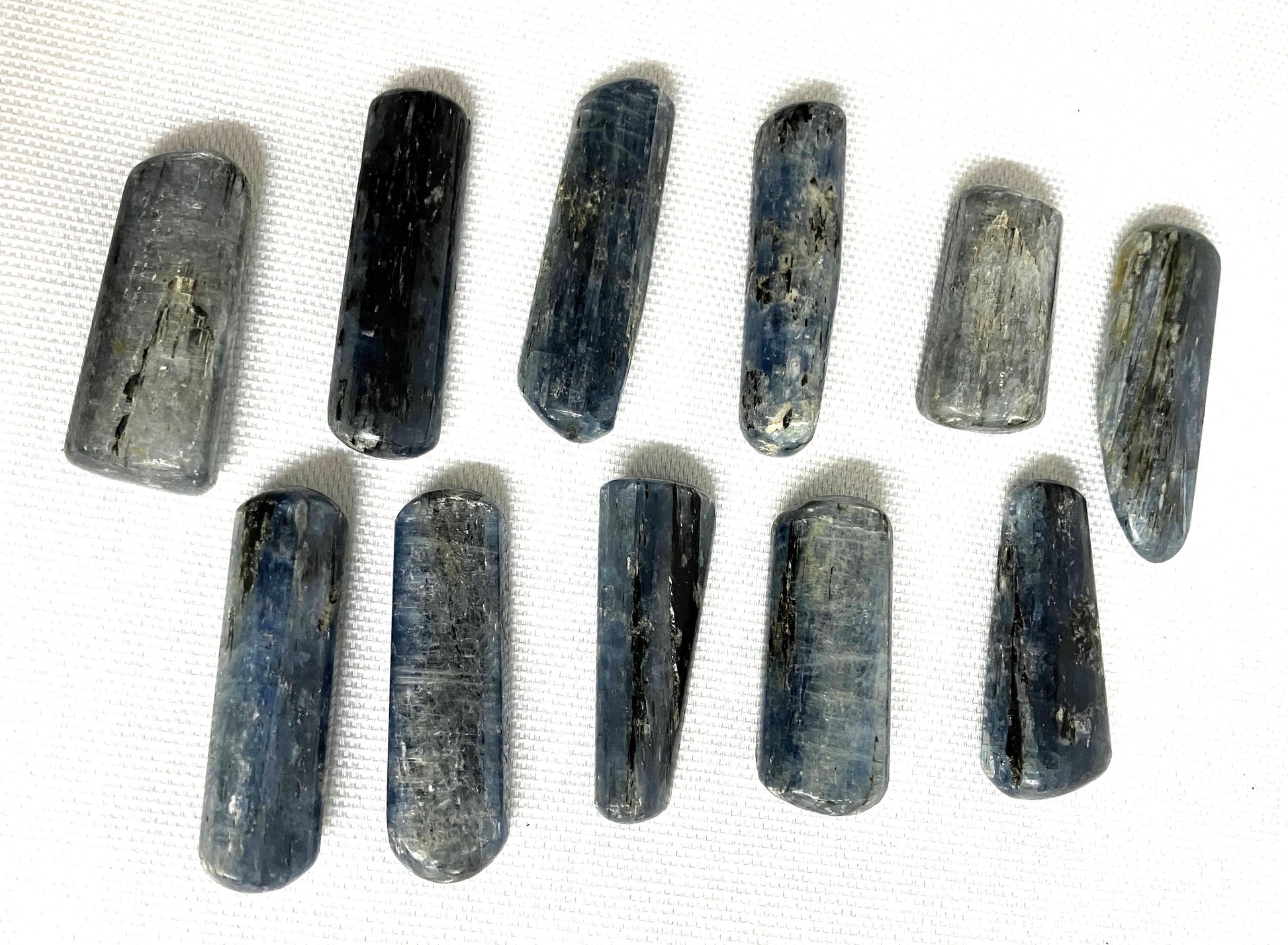 Row of Blue Kyanite Crystals on a white background