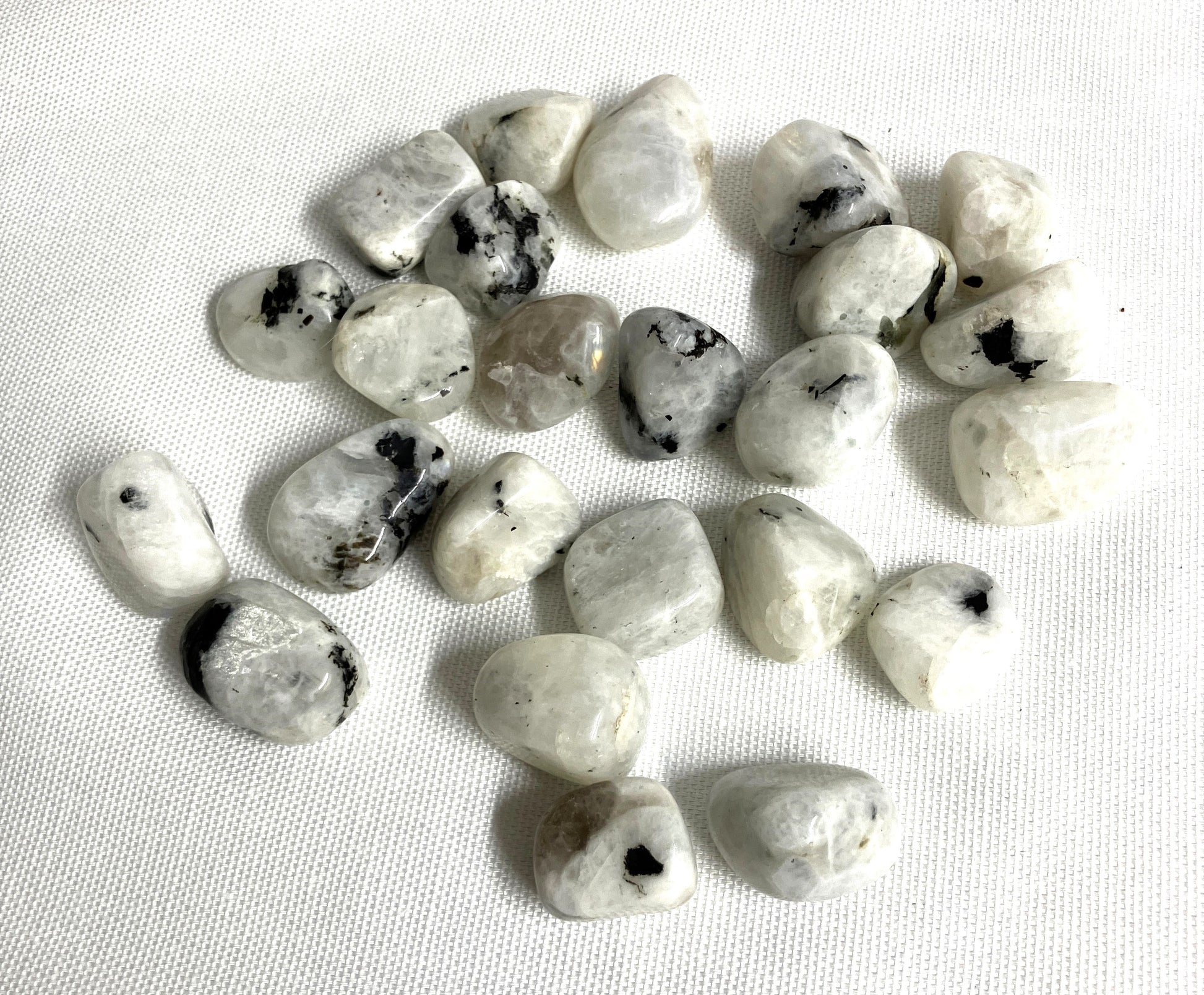 Rainbow Moonstone Crystals  on a white fabric background