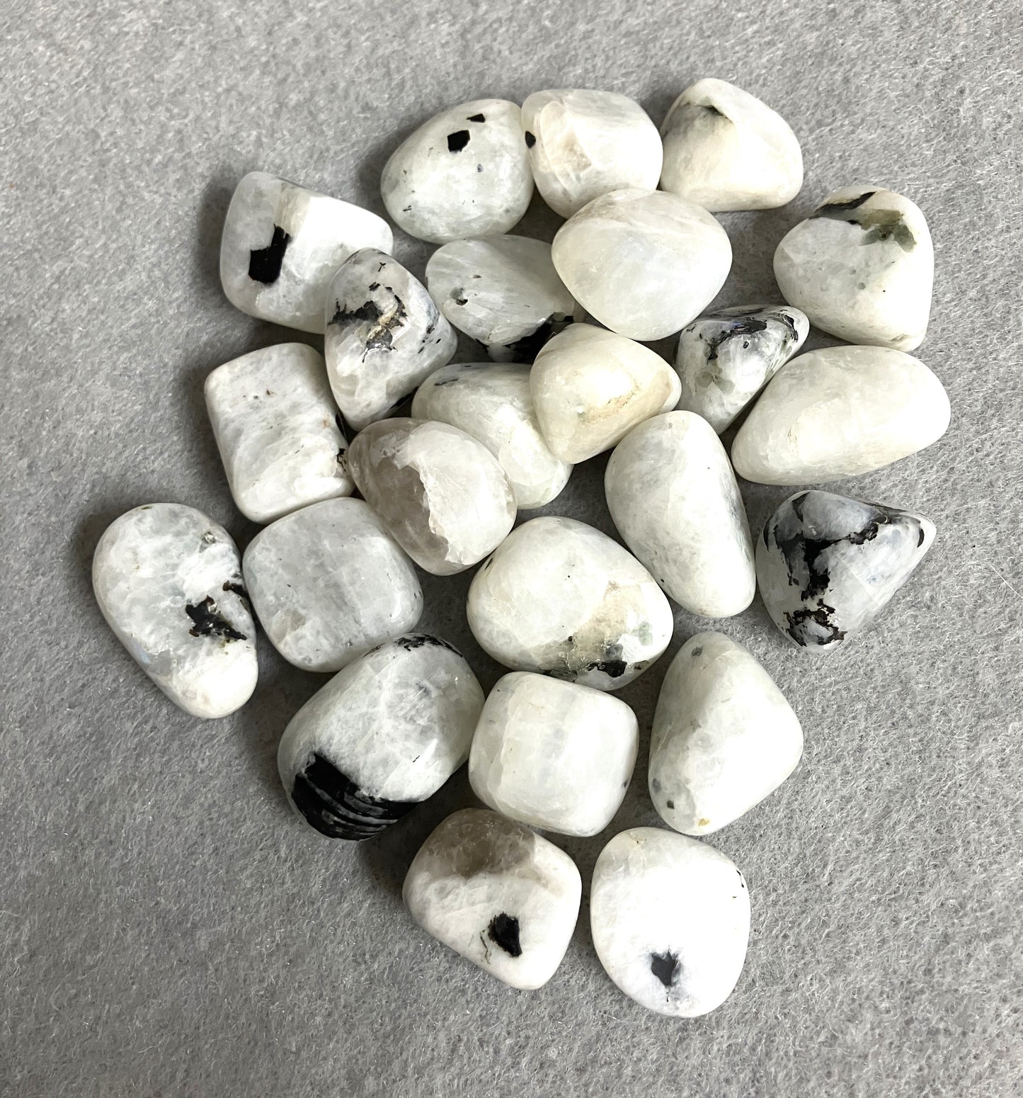 Back view of Rainbow Moonstone Crystals  on a gray surface