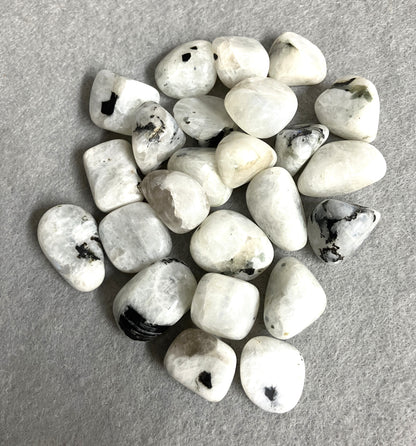 Back view of Rainbow Moonstone Crystals  on a gray surface