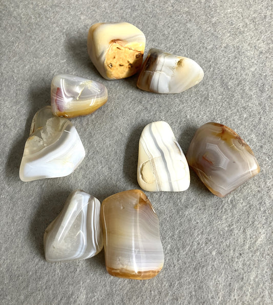 Top side view of Grey Banded Agate Crystals on a gray surface