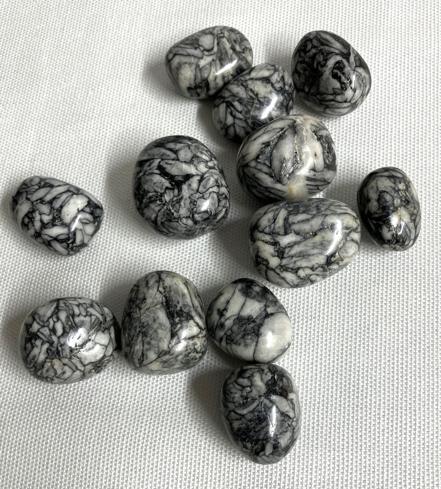 Pinolith Jasper Crystals showing the great pattern, on a light fabric background