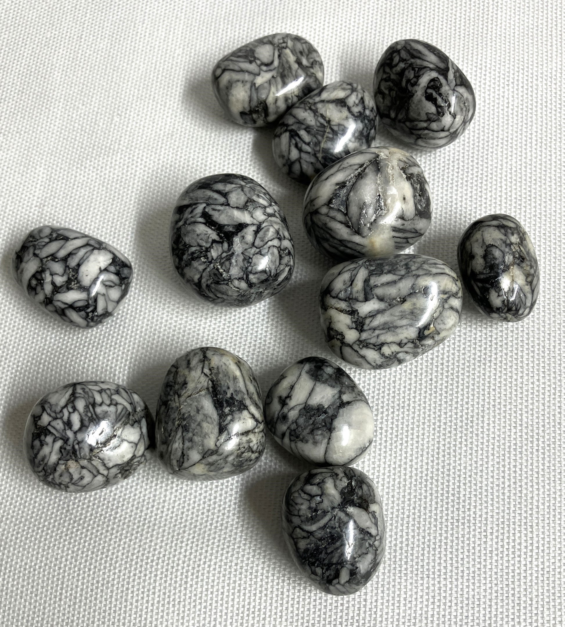 Pinolith Jasper Crystals showing the great pattern, on a light fabric background