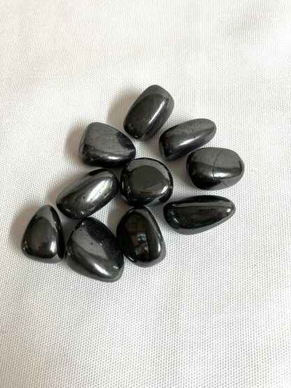 Top side of Hematite Crystals on a white fabric background