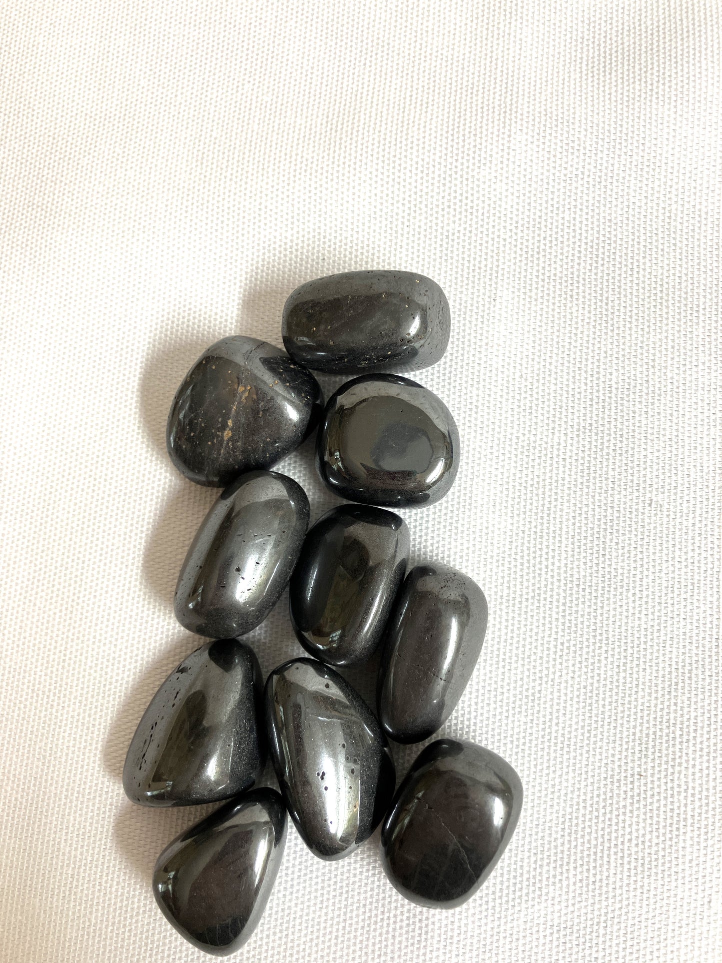 Group of Hematite Crystals on a white fabric background