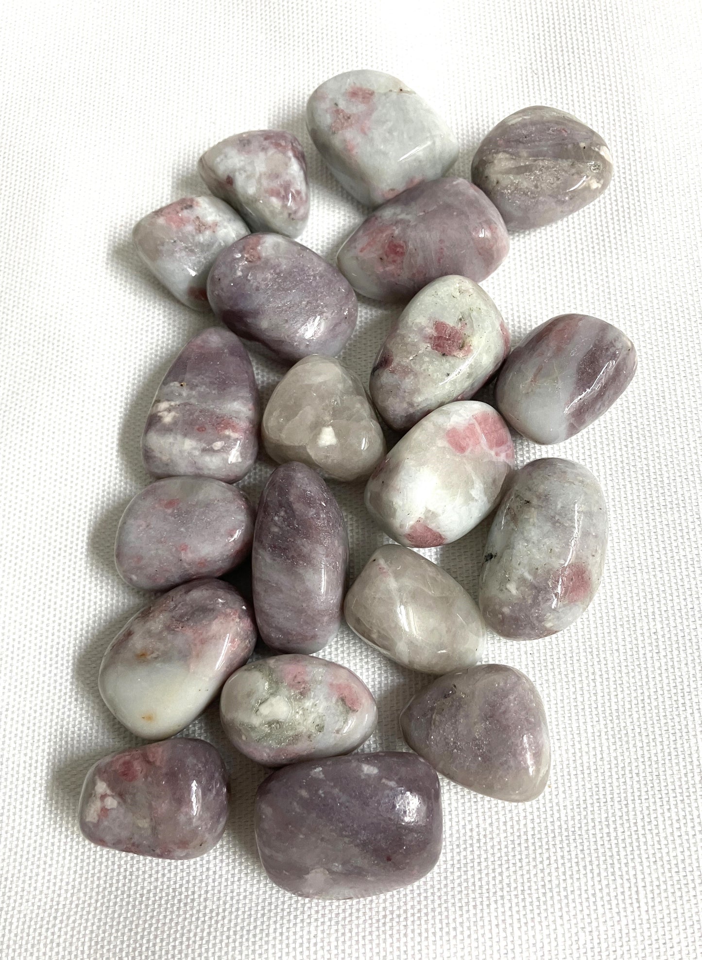 Front view of Pink Tourmaline Crystals on a white fabric background