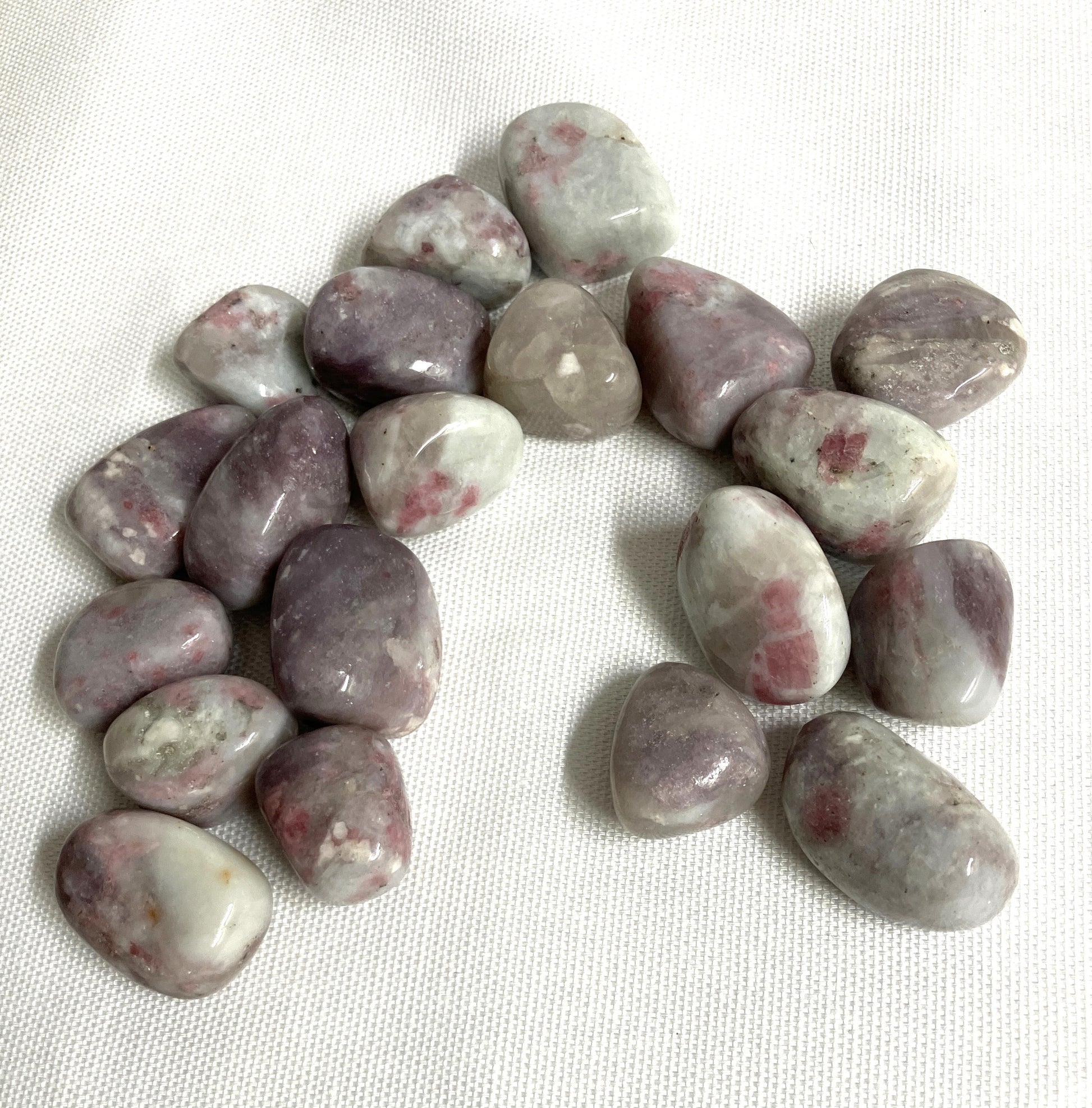 Closeup of Pink Tourmaline Crystals on a white fabric background