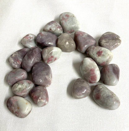 Closeup of Pink Tourmaline Crystals on a white fabric background