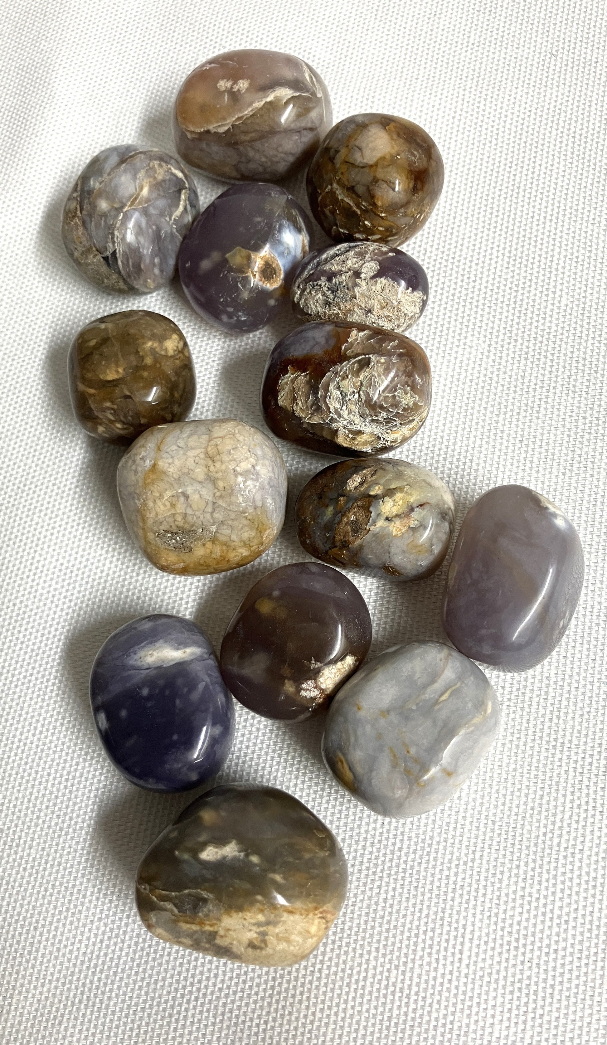 Collection of Purple Chalcedony Crystals on a light fabric background